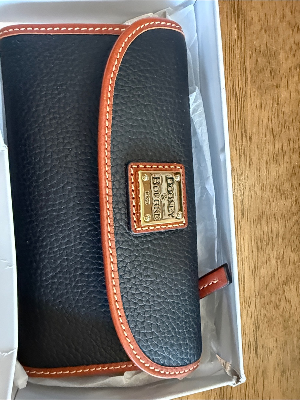 Dooney & Bourke Black Wallet with Brown Trim and Gold Plaque